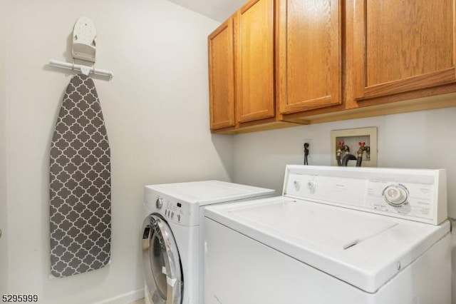 laundry area featuring washer and dryer and cabinet space