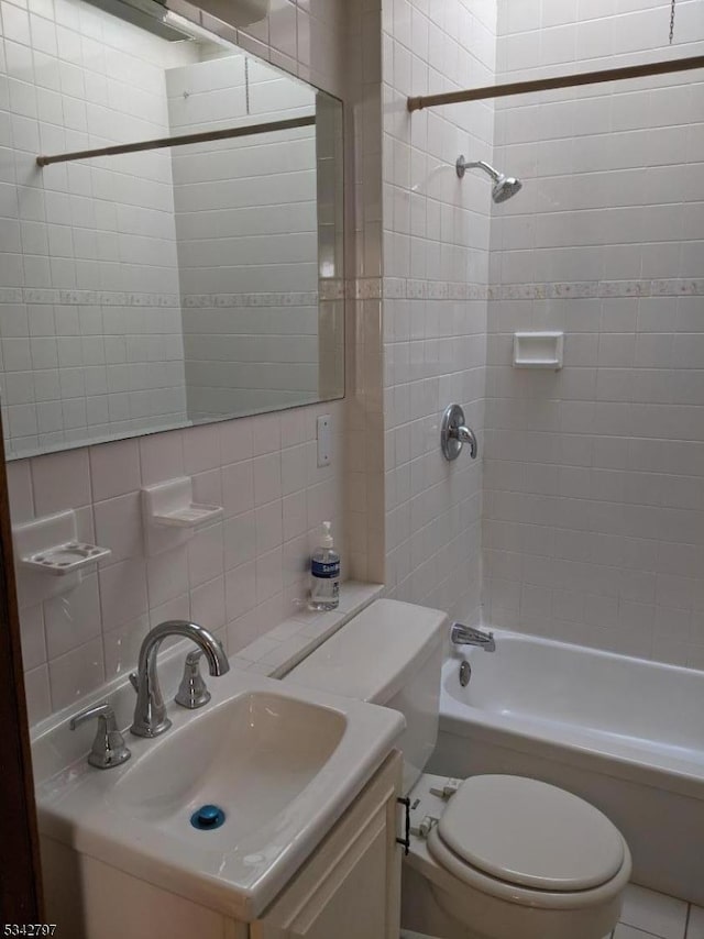 bathroom featuring vanity, bathtub / shower combination, tile walls, toilet, and backsplash