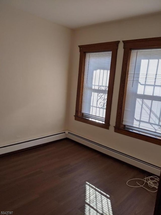 spare room with dark wood finished floors