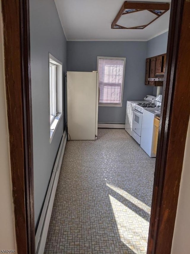 kitchen featuring white appliances, a baseboard radiator, ornamental molding, under cabinet range hood, and a baseboard heating unit