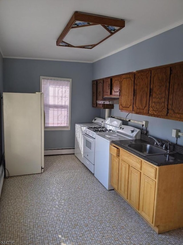 kitchen featuring white appliances, washer / dryer, a sink, a baseboard heating unit, and crown molding