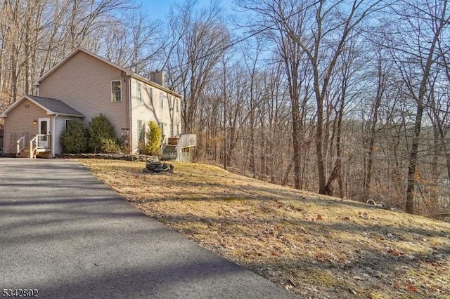 view of property exterior with a chimney