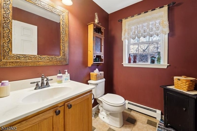 bathroom with toilet, a baseboard radiator, vanity, and baseboards