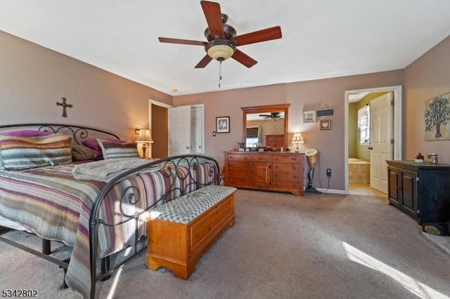 bedroom featuring carpet, ceiling fan, and ensuite bath