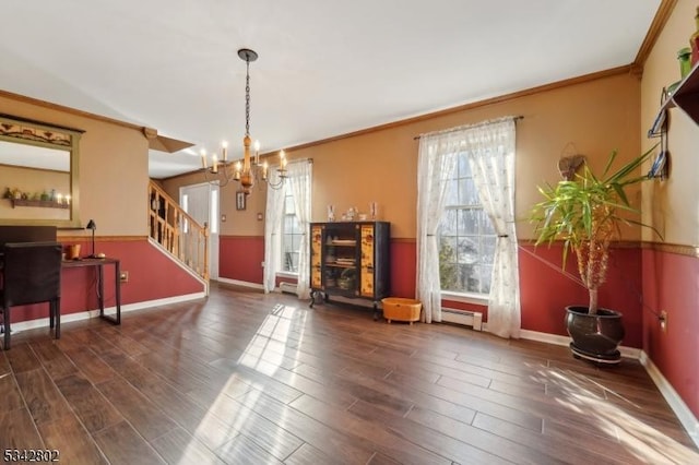 interior space with a notable chandelier, crown molding, wood finished floors, baseboards, and stairs