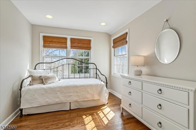 bedroom with recessed lighting, baseboards, and dark wood-type flooring