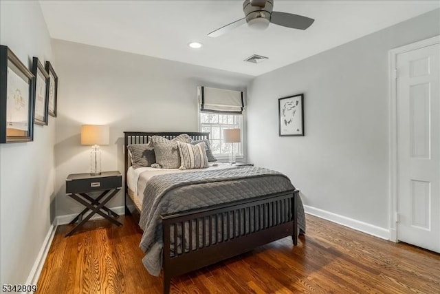 bedroom with recessed lighting, wood finished floors, visible vents, and baseboards