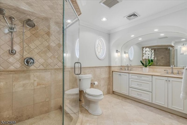 bathroom with visible vents, toilet, crown molding, and a sink