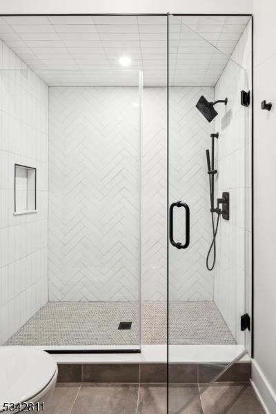 28 Old Forge Dr, Warren Twp, NJ 07059 - full bathroom featuring toilet, a stall shower, tile patterned floors, and baseboards