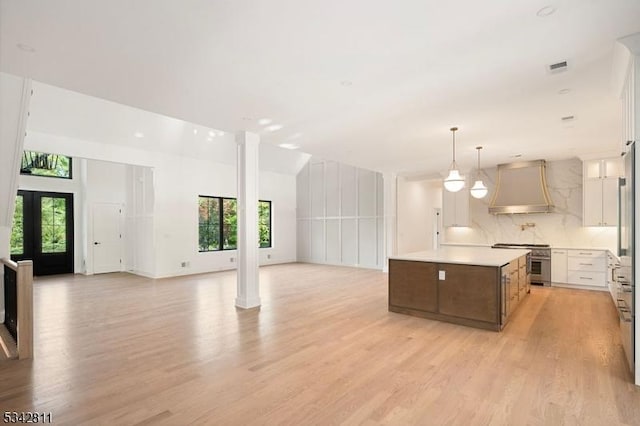28 Old Forge Dr, Warren Twp, NJ 07059 - kitchen featuring custom exhaust hood, stainless steel range, open floor plan, and healthy amount of natural light