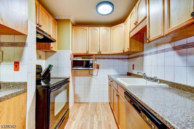 kitchen with a sink, light countertops, black electric range oven, dishwasher, and stainless steel microwave