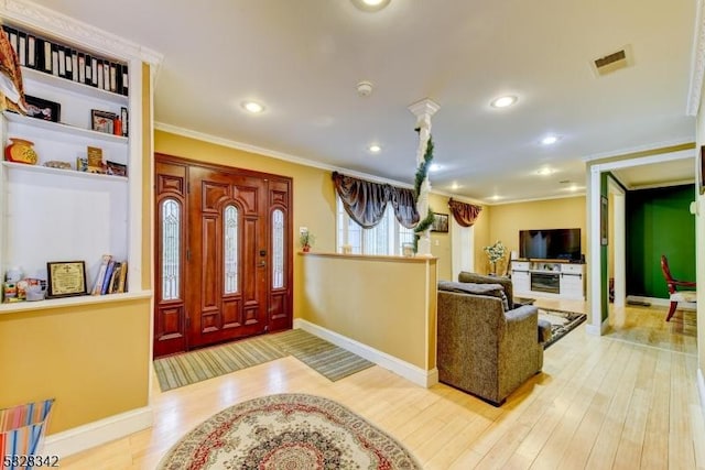 entryway featuring recessed lighting, visible vents, crown molding, and wood finished floors