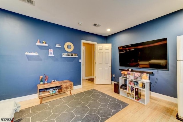 rec room with recessed lighting, visible vents, baseboards, and wood finished floors