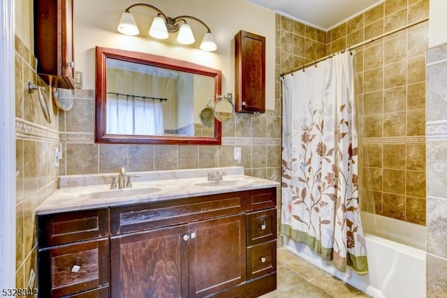 full bath with shower / tub combo with curtain, a sink, tile walls, and tile patterned floors