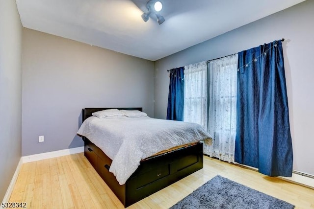 bedroom with wood finished floors and baseboards