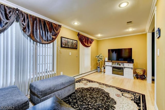 living area with recessed lighting, a baseboard heating unit, wood finished floors, visible vents, and crown molding