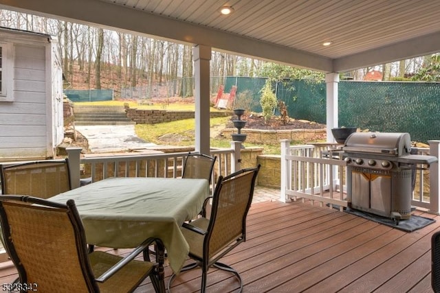 deck featuring a fenced backyard and grilling area