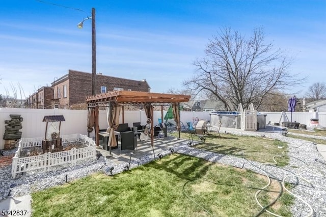 view of yard featuring a patio area, a pergola, and a fenced backyard