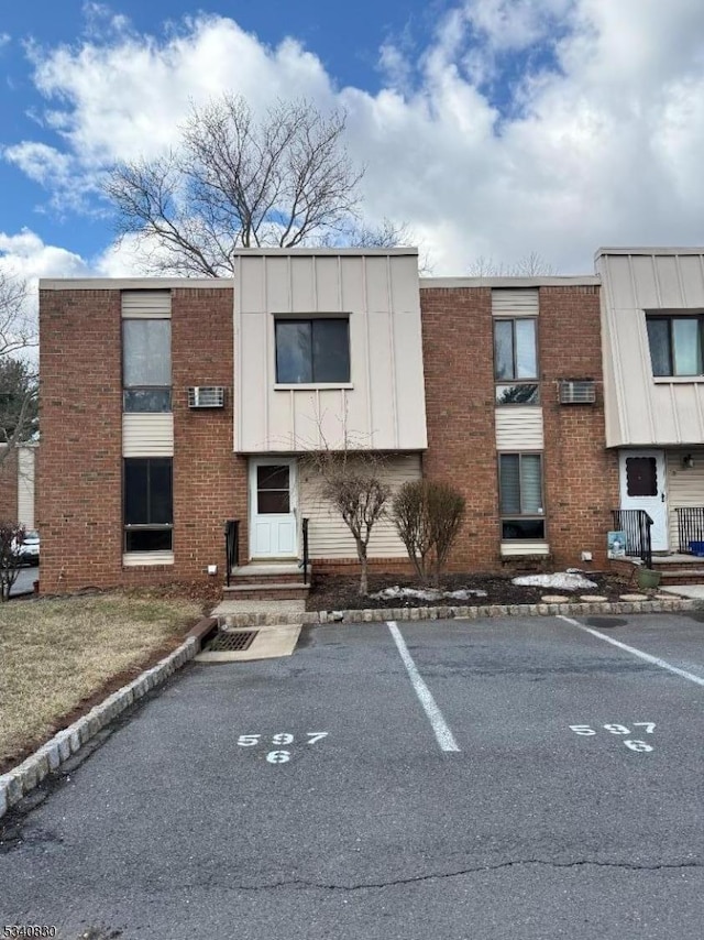 view of building exterior with uncovered parking