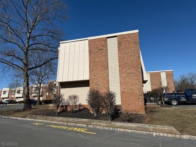 view of property exterior with brick siding