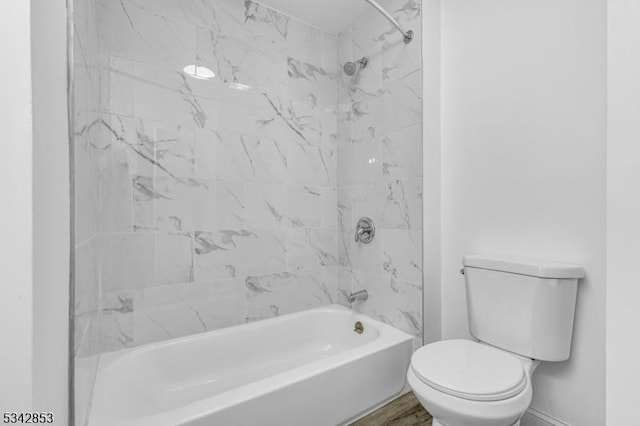 full bathroom with baseboards, toilet, and washtub / shower combination