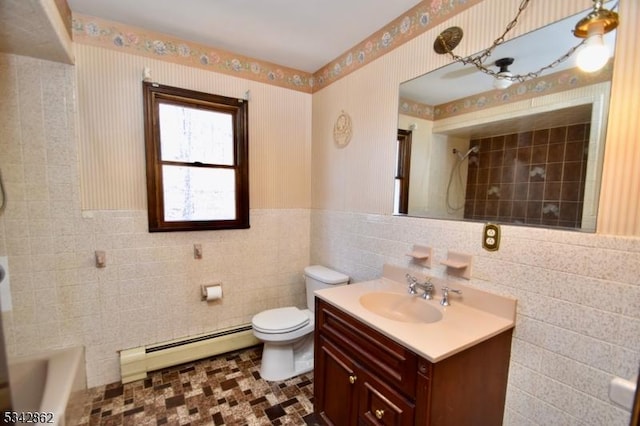 full bathroom featuring wallpapered walls, a baseboard heating unit, toilet, vanity, and tile walls