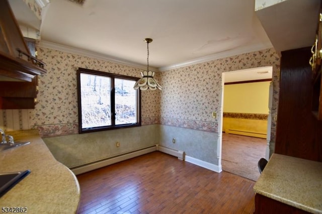 dining room featuring dark wood-style floors, a baseboard radiator, wallpapered walls, and ornamental molding