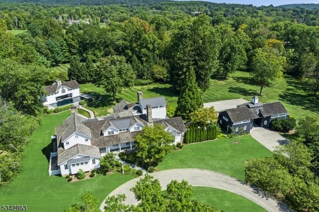 drone / aerial view featuring a wooded view