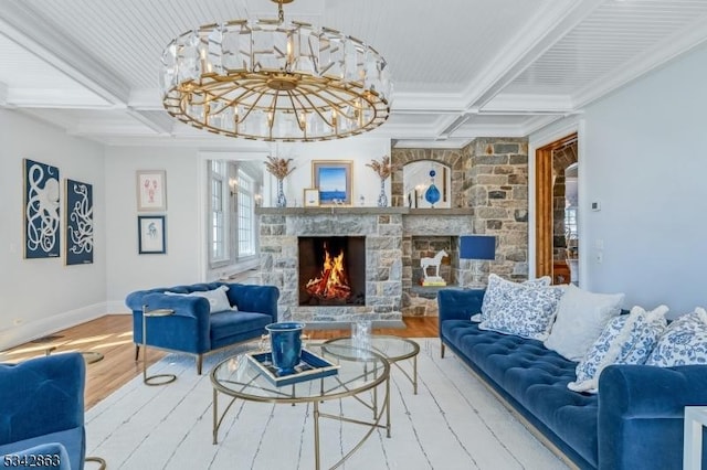 living room with baseboards, a stone fireplace, wood finished floors, a notable chandelier, and coffered ceiling