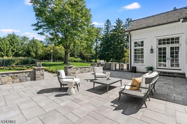 view of patio featuring french doors and an outdoor kitchen