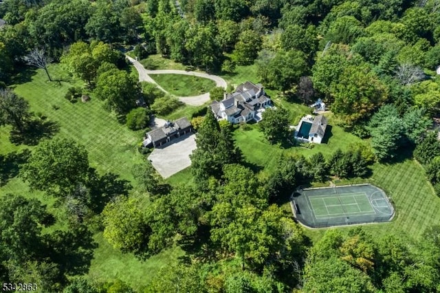 bird's eye view with a wooded view