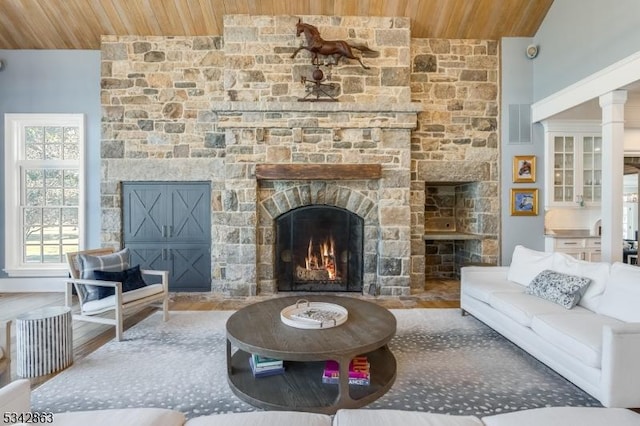 sitting room featuring visible vents, wooden ceiling, a fireplace, and vaulted ceiling