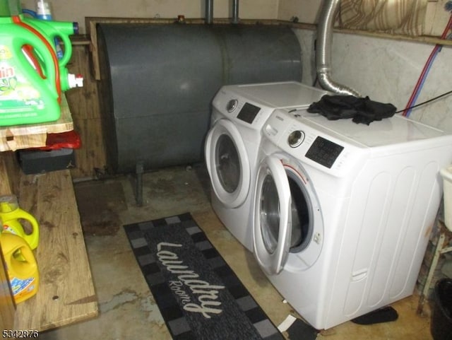 laundry area featuring laundry area, heating fuel, a garage, and separate washer and dryer