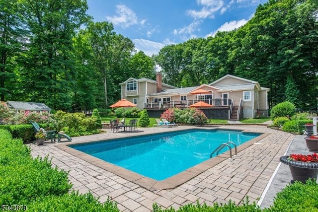 pool featuring a patio and a wooden deck