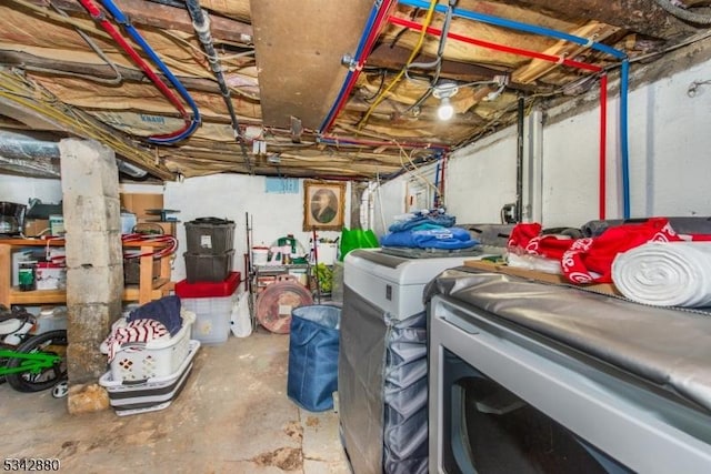 unfinished basement featuring washing machine and dryer