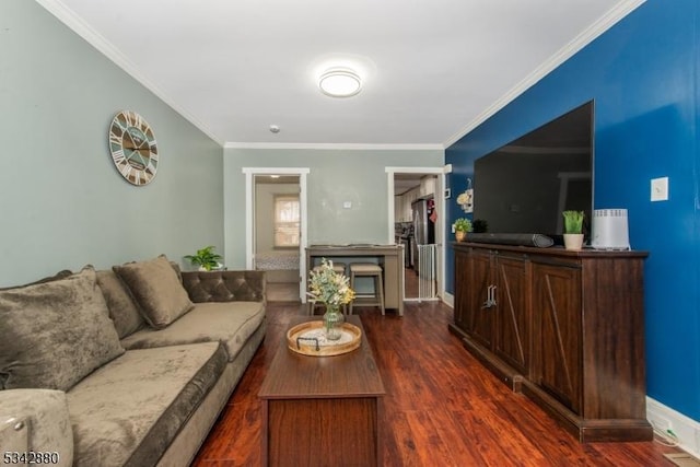 living area with dark wood-type flooring, baseboards, and ornamental molding