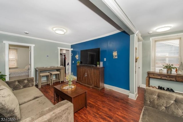 living area featuring ornamental molding, baseboards, and wood finished floors