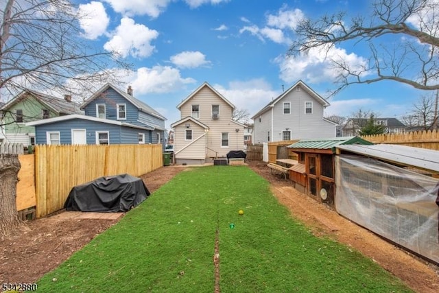 view of yard featuring exterior structure, fence private yard, and an outdoor structure