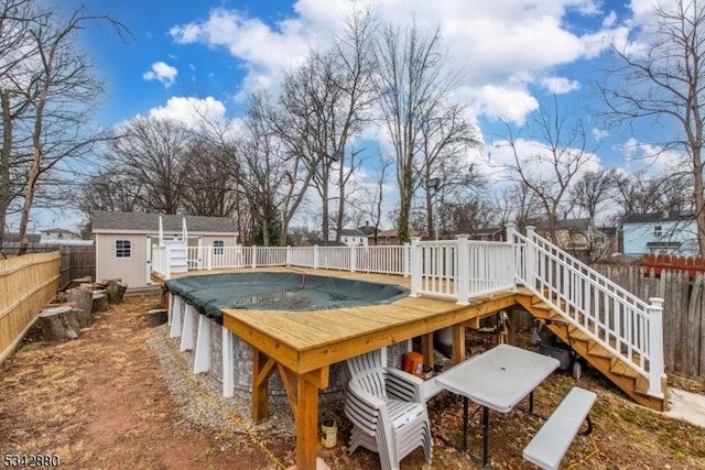 view of swimming pool featuring a fenced in pool, a shed, stairway, a fenced backyard, and an outdoor structure