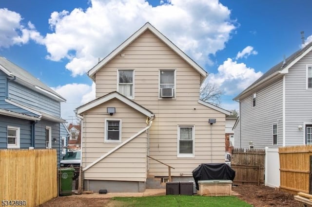 back of house with cooling unit and fence