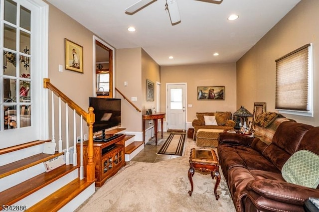 tiled living room with recessed lighting, a ceiling fan, a wealth of natural light, and stairs