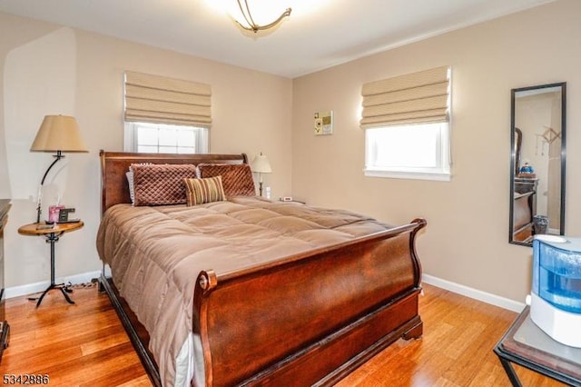 bedroom featuring light wood-type flooring and baseboards