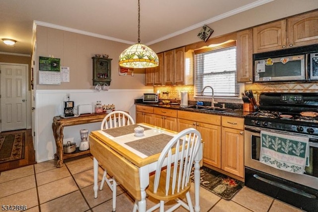 kitchen featuring a sink, dark countertops, backsplash, appliances with stainless steel finishes, and crown molding