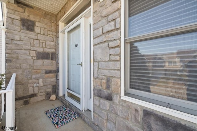 doorway to property featuring stone siding