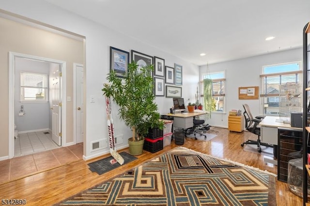 office space featuring recessed lighting, light wood-type flooring, and baseboards