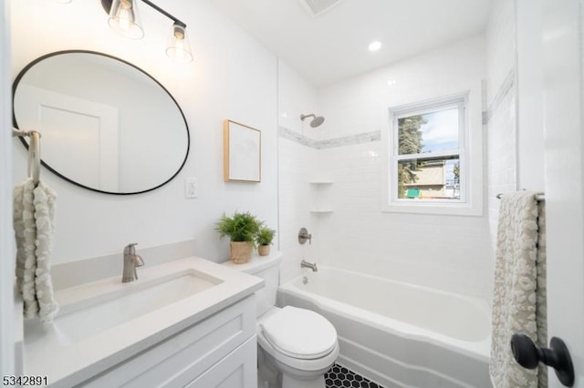 bathroom featuring shower / washtub combination, toilet, and vanity