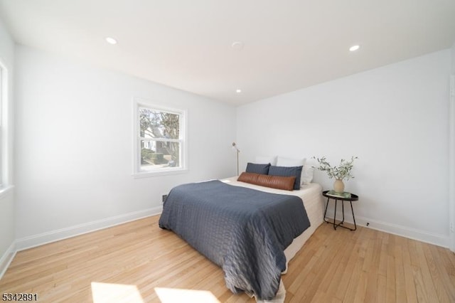 bedroom featuring recessed lighting, baseboards, and light wood-type flooring