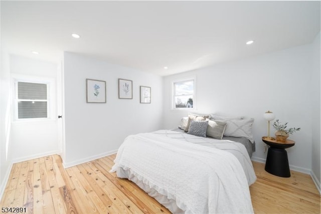 bedroom with recessed lighting, baseboards, and light wood-style flooring