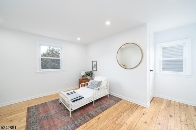 bedroom featuring light wood finished floors, recessed lighting, and baseboards