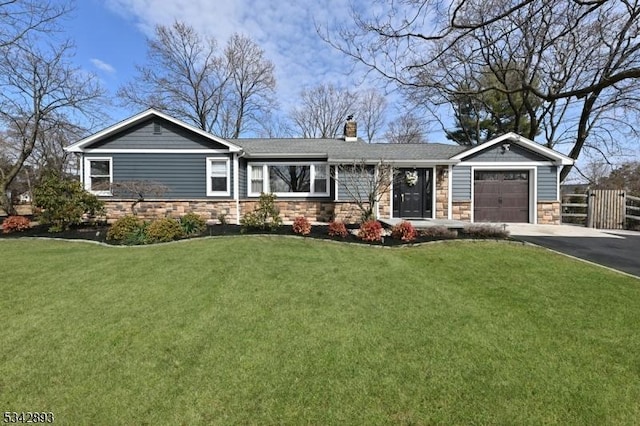 ranch-style home featuring driveway, stone siding, fence, a front yard, and a garage